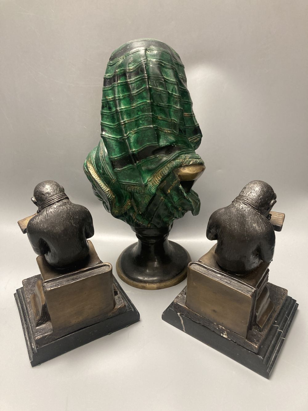 A pair of bronze monkey bookends and a cold painted bronze bust of a Nubian lady, height 32cm